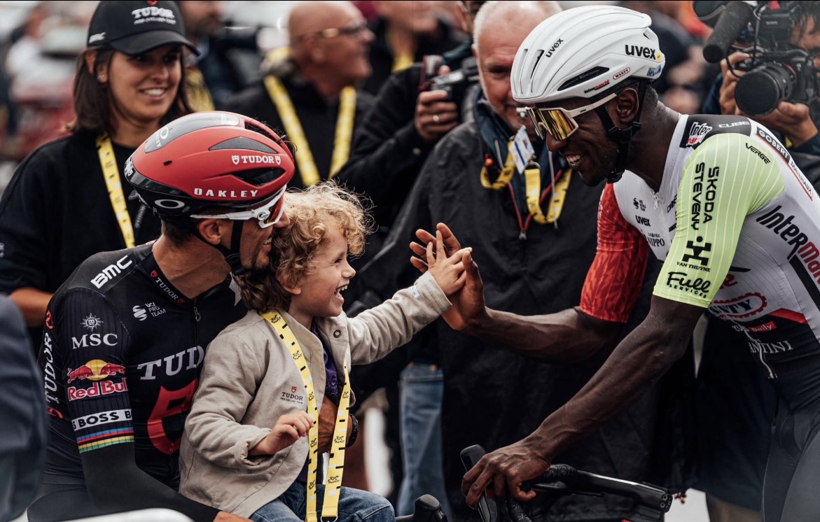 Inspiring moment between professional cyclists and young fan